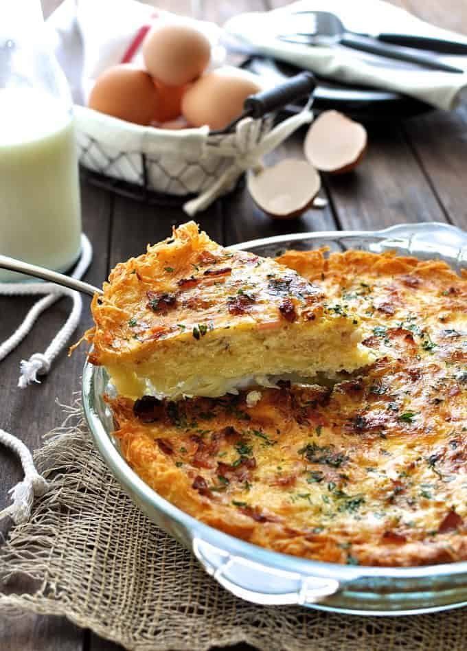 Slice of Hash Brown Crust Quiche Lorraine being lifted out a pie dish.