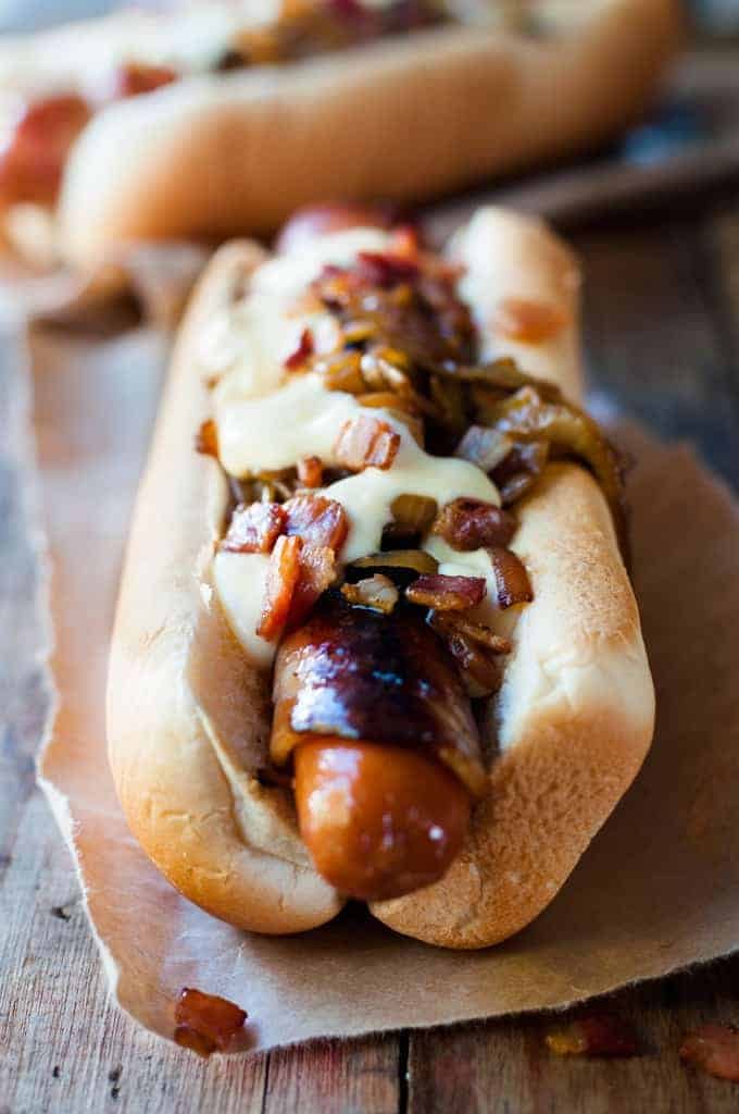 Closeup of Bacon Wrapped Hot Dogs with Cheese Sauce