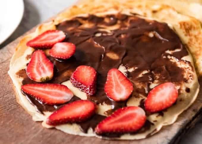 Nutella Crepes with Strawberries - The batter is a 10 second job when made with a blender! And you do not need a crepe pan, just a skillet! recipetineats.com