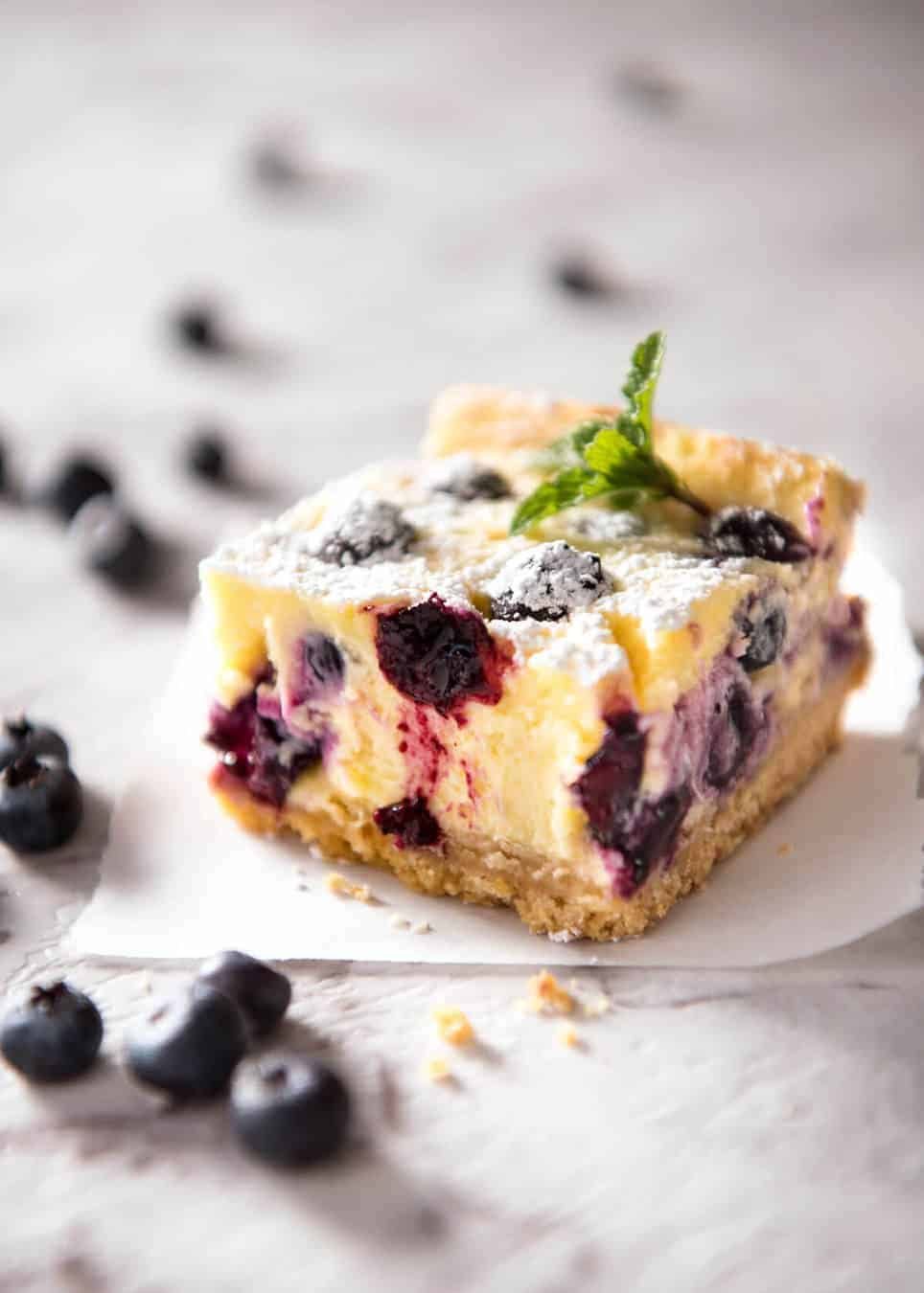 These Blueberry Cheesecake Bars are light yet creamy and luscious. Filled with soft blueberries, this is a baked cheesecake that's so easy to make! www.recipetineats.com
