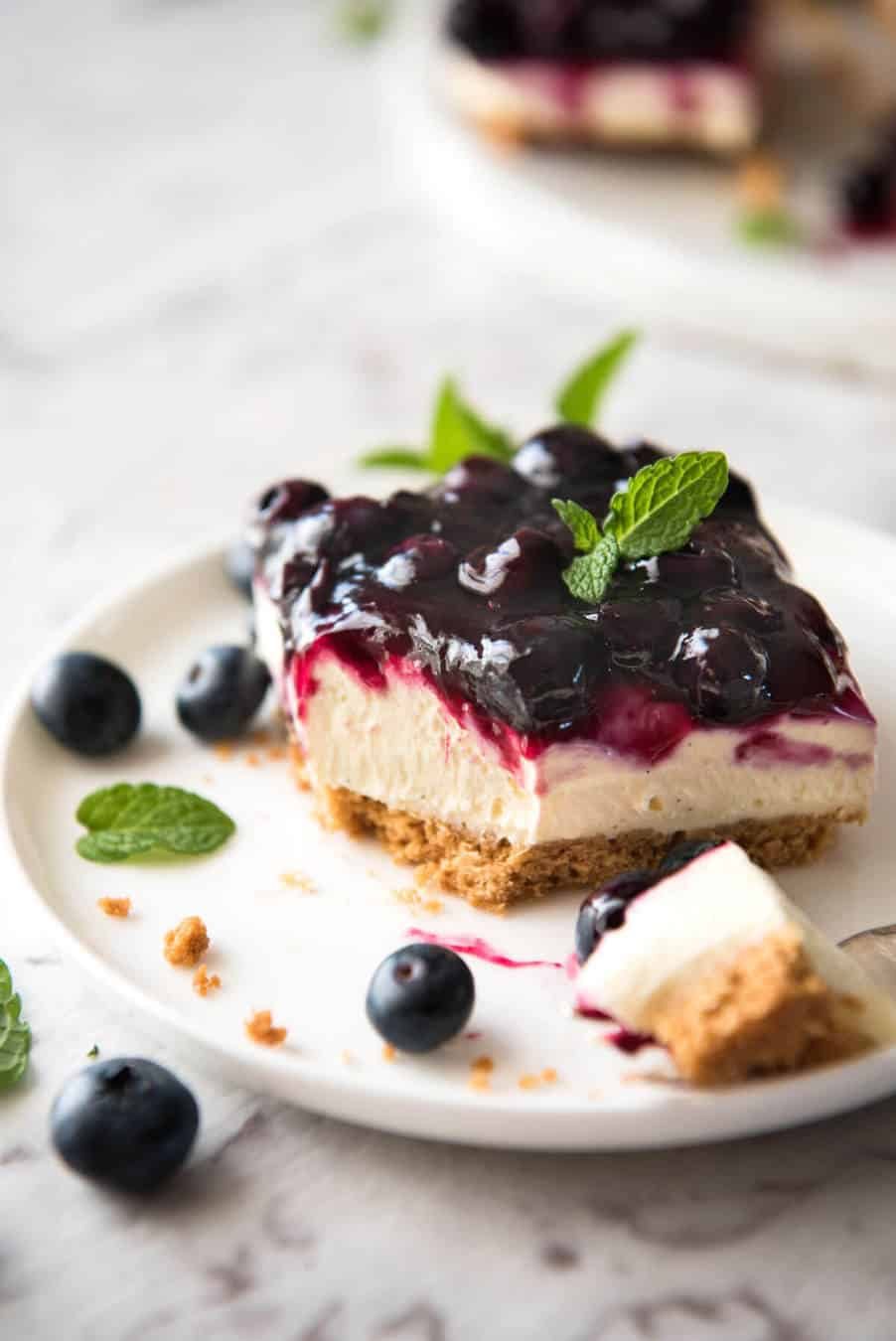 Easy and fast No Bake Blueberry Cheesecake Bars - creamy cheesecake with a gorgeous fresh blueberry sauce topping! www.recipetineats.com