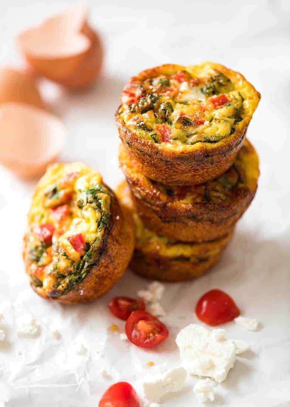 Healthy doesn't have to be bland! These Healthy Egg Muffins are a great grab & go breakfast option. Egg, spinach, feta, cherry tomatoes and bell peppers/capsicum. www.recipetineats.com
