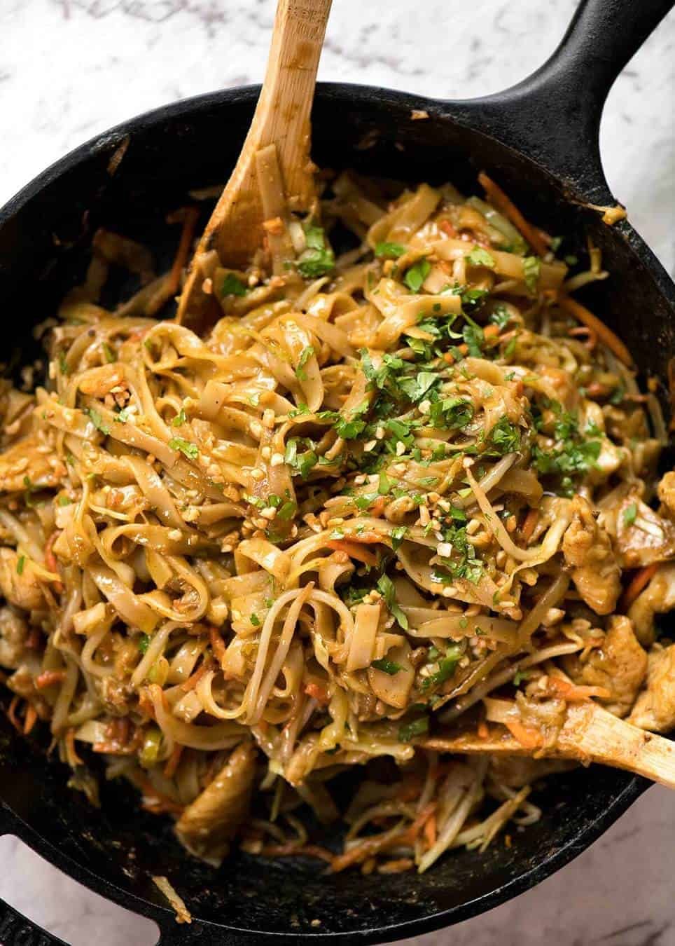 Satay Peanut Noodles in a black skillet, fresh off the stove