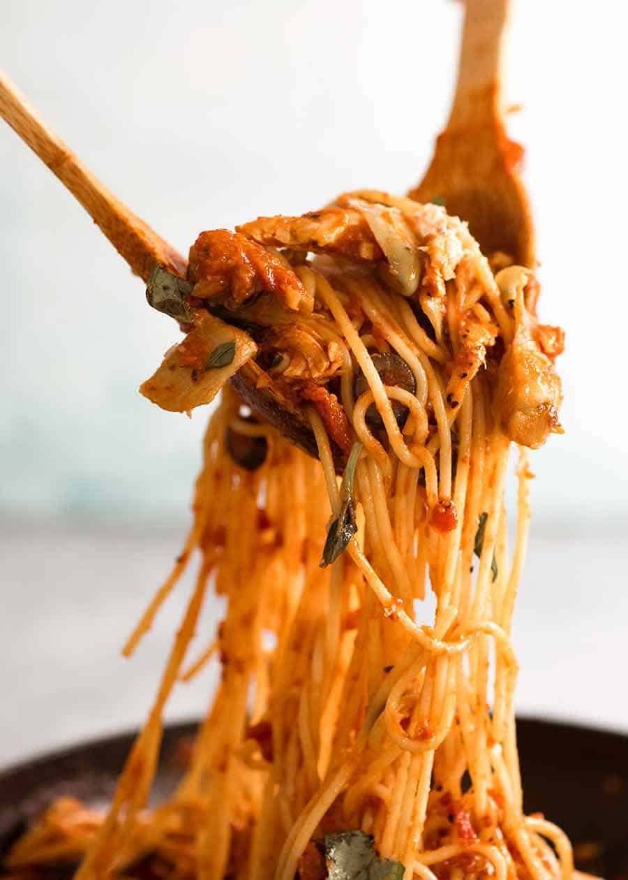 Sicilian Chicken Spaghetti being tossed in sauce