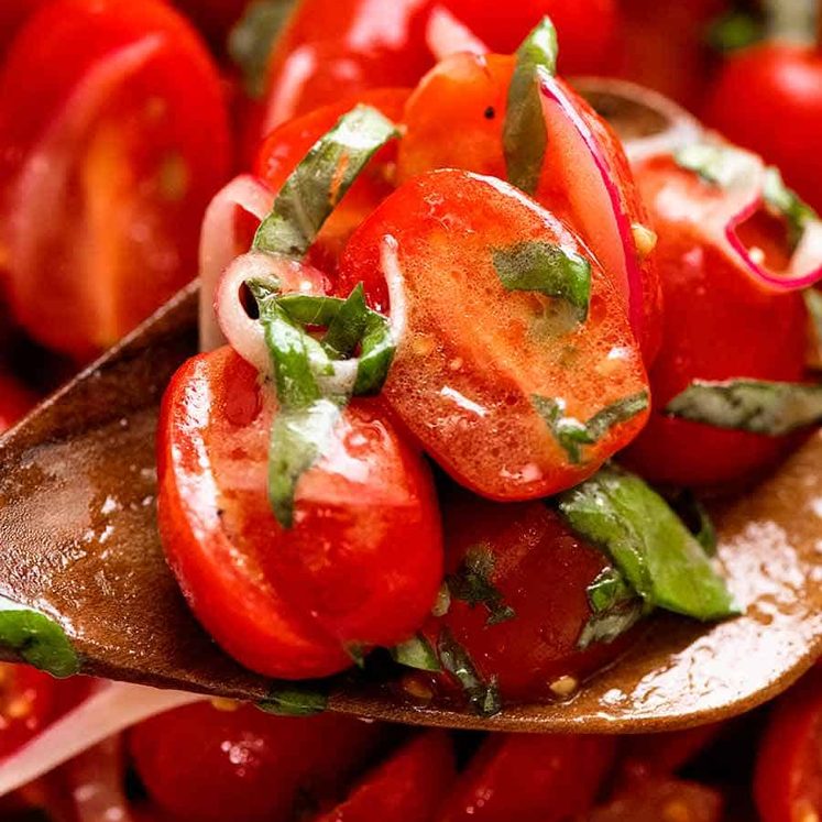 Close up of spoon scooping up Tomato Salad