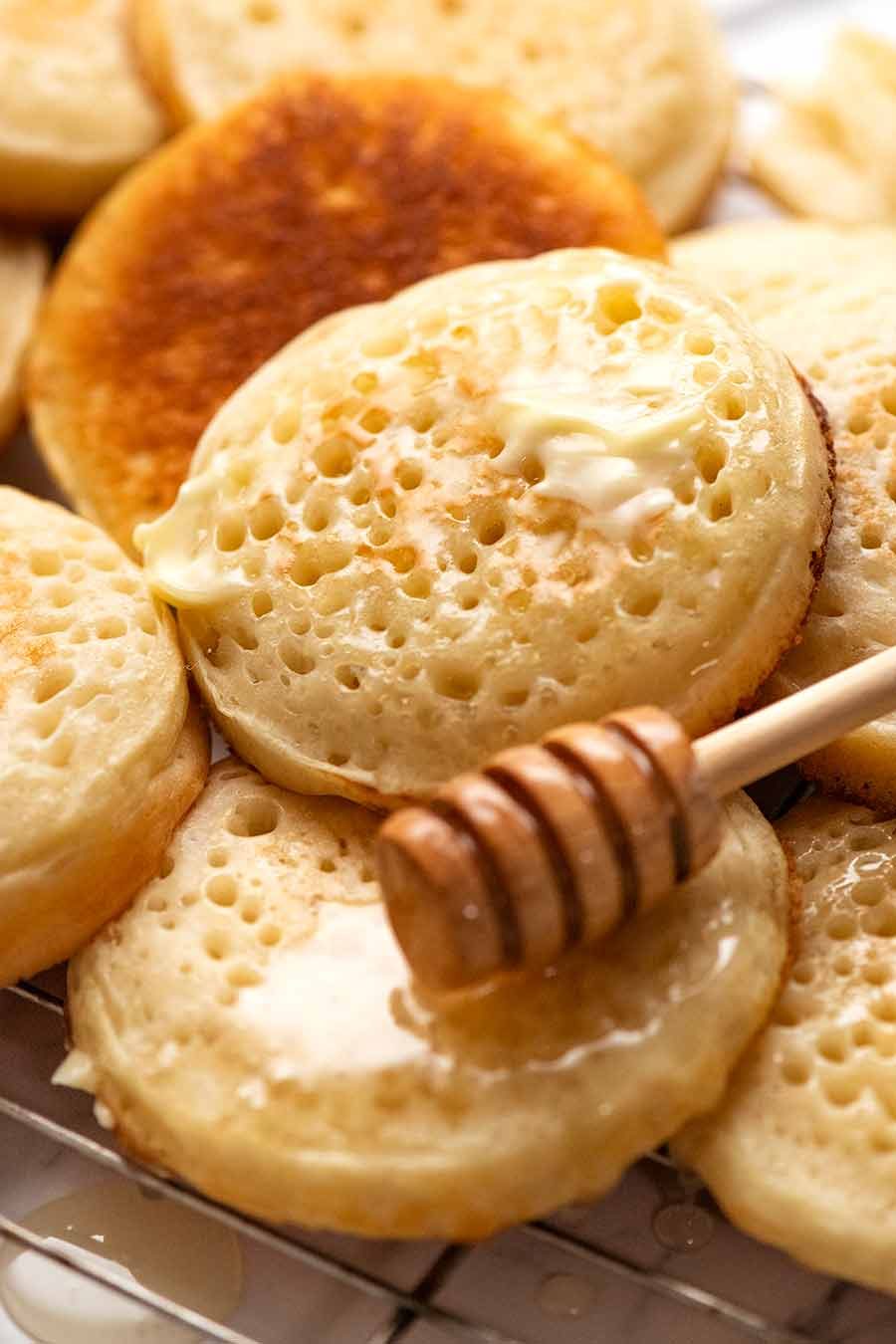 Close up of homemade crumpets with honey and butter