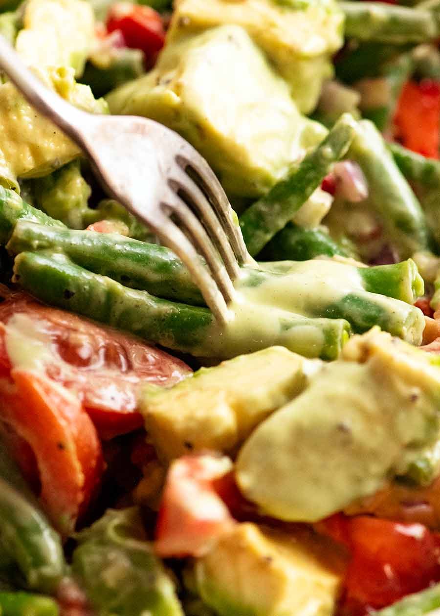 Fork stabbing Green Bean Avocado Salad with Avocado Dressing