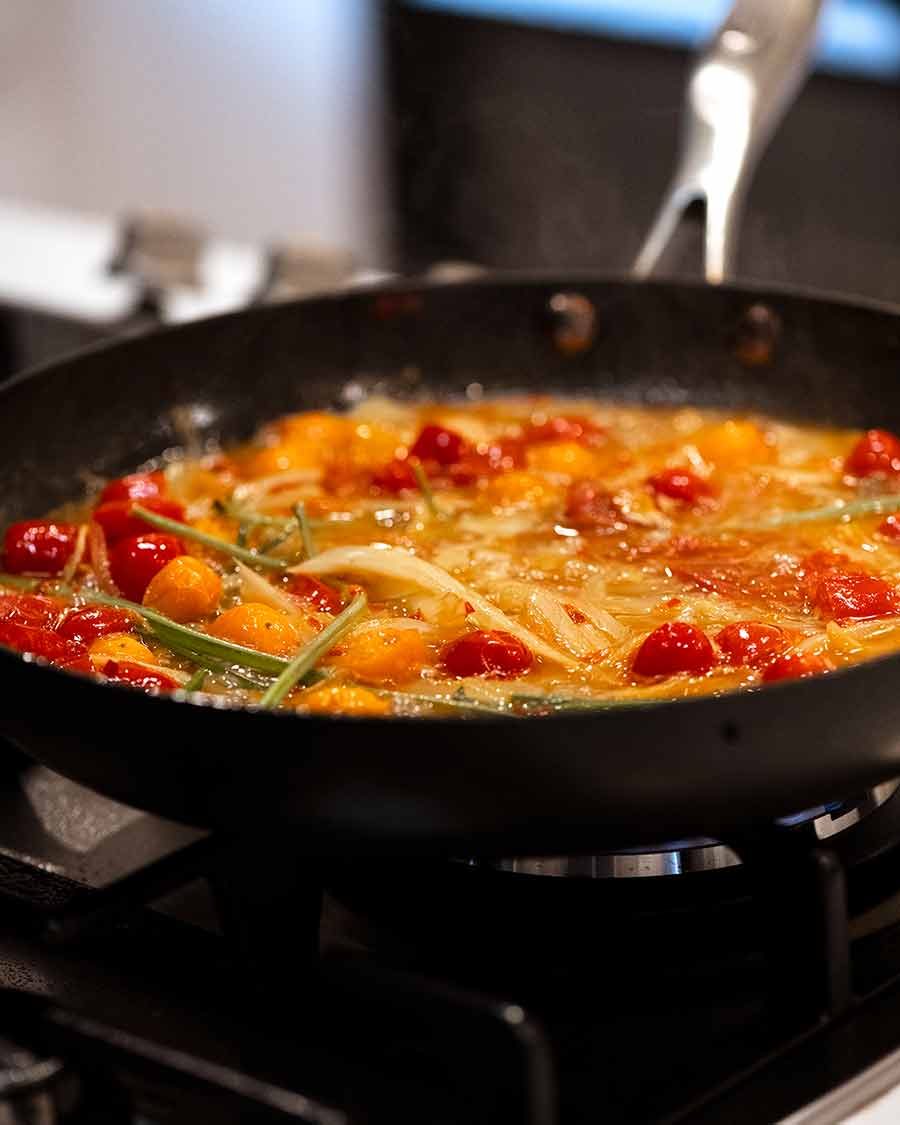 Sauce for Acqua Pazza - Italian Poached Fish, simmering on the stove.