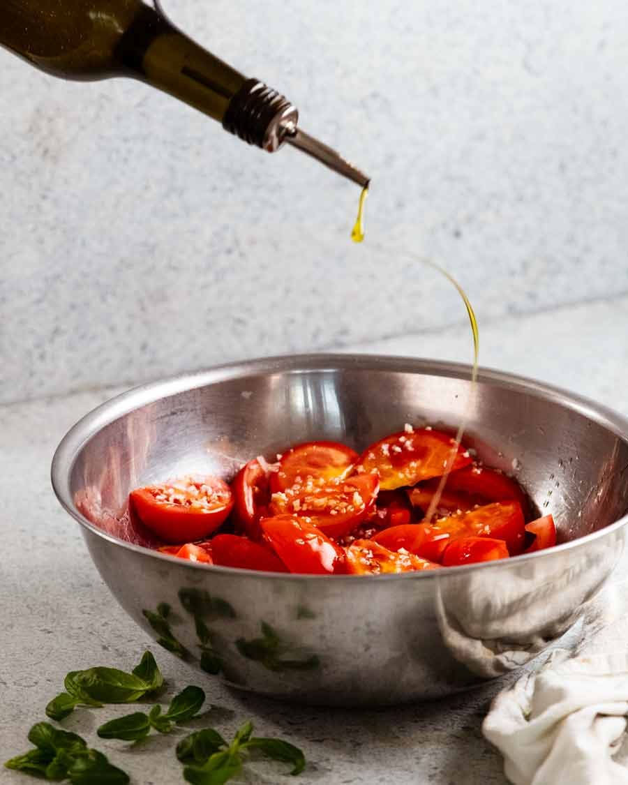 Drizzling oil over My favourite Tomato Salad